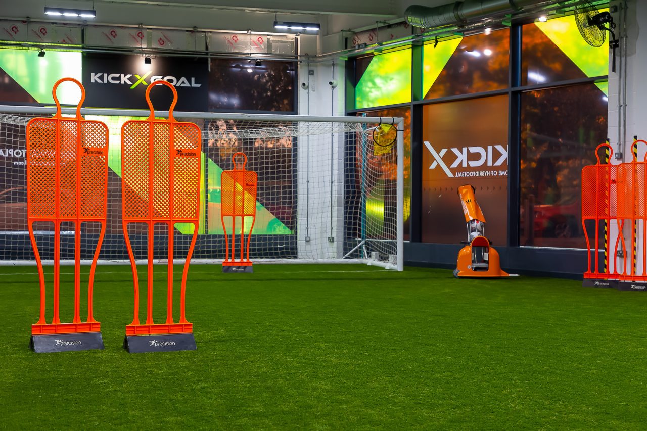 Ball launcher at KickX Arena with 2 orange mannequins in a full size goal